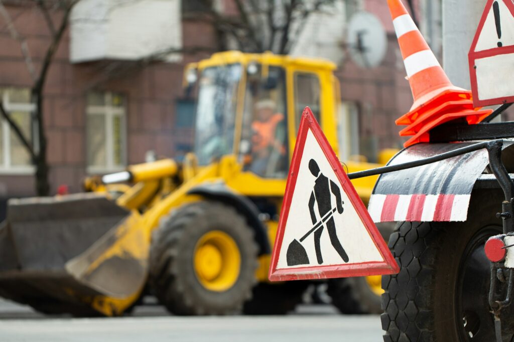 Warning street sign on road work site.